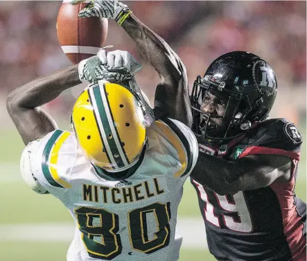  ?? WAYNE CUDDINGTON / POSTMEDIA ?? Ottawa’s Imoan Claiborne, right, is called for illegal contact on Edmonton receiver Bryant Mitchell last season. The league’s rules committee said Thursday coaches will no longer have the ability to challenge plays involving illegal contact on...