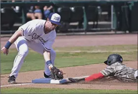  ?? (NWA Democrat-Gazette/Charlie Kaijo) ?? Northwest Arkansas Naturals infielder Cayden Wallace (left) attempts to tag out Jonatan Clase of the Arkansas Travelers during Sunday’s game at Arvest Ballpark in Springdale. The Travelers won 7-3.