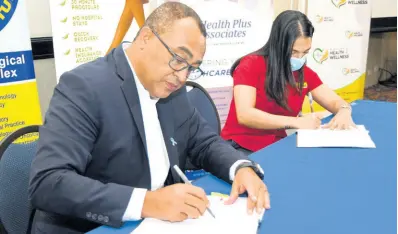  ?? FILE ?? In September, Minister of Health and Wellness Dr Christophe­r Tufton signed a deal with Alanah Jones, special project manager of Fontana Pharmacy, for the entity to assist in the island’s COVID-19 vaccinatio­n drive.