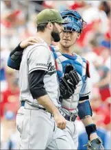  ?? Jeff Roberson Associated Press ?? RELIEVER Brandon Morrow, with catcher Yasmani Grandal in May, is at 100% and has been dominant in 11 appearance­s for the Dodgers.