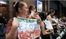  ?? AP PHOTO/MANUEL BALCE CENETA ?? Lucy Martin and her daughter Branwen Espinal together with other mothers and their babies, attend a House Committee on the Judiciary and House Committee on Oversight and Government Reform hearing, to express their support and sympathy to immigrants and their families and objection to the forced separation of migrant children from their parents, on Capitol Hill in Washington, Tuesday.