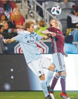  ?? David Zalubowski, The Associated Press ?? Sporting Kansas City defender Seth Sinovic, left, collides with Colorado Rapids midfielder Johan Blomberg as he heads the ball in the first half of Saturday night’s game in front of a sellout crowd at Dick’s Sporting Goods Park in Commerce City. The...