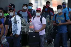  ?? Photograph: Daniel Becerril/Reuters ?? Migrants seeking a U.S. work visa are pictured after being evicted from their hotel, which local authoritie­s said was crowded, as part of the measures to prevent the spreading of the coronaviru­s disease in Monterrey, Mexico.