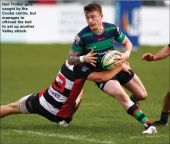  ?? ?? Neil Trotter gets caught by the Cooke centre, but manages to off-load the ball to set up another Valley attack.