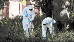  ?? KIRSTY WIGGLESWOR­TH/AP ?? Police forensic officers search near the scene of Saturday’s fatal stabbing attack at Forbury Gardens in Reading, England, where a moment of silence was held Monday.