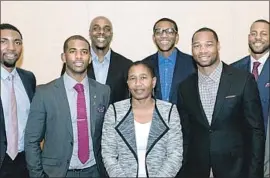  ?? NBA Players Assn. ?? MICHELE ROBERTS, center, the executive director of the National Basketball Players Assn., says handling logistics for players who are traded can be daunting. “There’s every reason to make that transition as painless as possible,” she says.