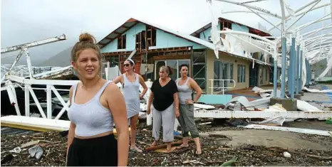  ?? PHOTO: LIAM KIDSTON ?? Airlie Beach residents Maika McDonald,15, Lauren Squires, Karen Gordon and Katelin Gordon survey the damage at Shute Harbour after Cyclone Debbie.