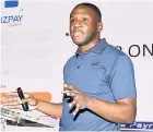  ??  ?? Kyle Hibbert, MC Systems’ software developer, explaining the payroll app, BizPay Cash to patrons who attended the MC Systems Jamaica Payroll Conference last week at The Jamaica Pegasus hotel in New Kingston.