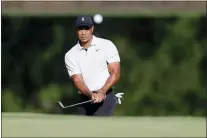 ?? MIKE SIMONS — TULSA WORLD VIA AP ?? Tiger Woods hits a chip shot on the 11th hole during a practice round Monday for the PGA Championsh­ip at Southern Hill Country Club in Tulsa, Okla. It’s the fifth time the course has hosted the championsh­ip.