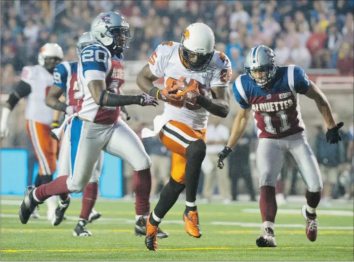  ?? — THE CANADIAN PRESS FILES ?? B.C. Lions’ Shawn Gore, centre, breaks away from Montreal Alouettes’ Byron Parker, left, and Chip Cox to score a touchdown during first-half action in Montreal on Thursday night. The Lions had a defensive meltdown and blew a 15-point lead to lose to...