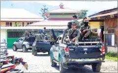  ?? ANYONG/AFP ?? Indonesian Mobile Brigade Police head to Nduga, where thirty-one constructi­on workers are believed to have been shot dead.