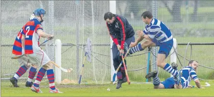  ?? Photograph: Annie Macdonald. ?? Kingussie keeper Rory McGregor stands up to the challenge from Newtonmore’s Glen Mackintosh during the cottages.com MacTavish Cup semi-final.