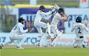  ?? AP ?? GRITTY KNOCK: BJ Watling plays a shot during the third day of the first Test against Sri Lanka in Galle. —