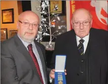  ??  ?? John Scannell (right) receiving a presentati­on from Bill Smith, Director General of the Civil Defence at his retirement event in February 2015. Photos: Eugene Cosgrove