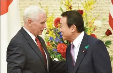  ?? KAZUHIRO NOGI/AFP ?? US Vice President Mike Pence (left) shakes hands with Japan’s Deputy Prime Minister and Minister of Finance Taro Aso following a joint press conference in Tokyo on April 18.