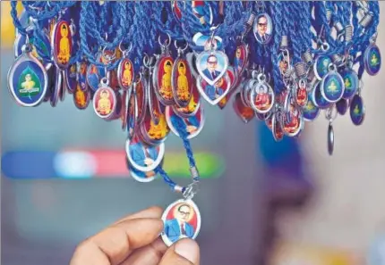  ?? AFP ?? ▪ Lockets of BR Ambedkar for sale near the Chaitya Bhoomi memorial in Mumbai.