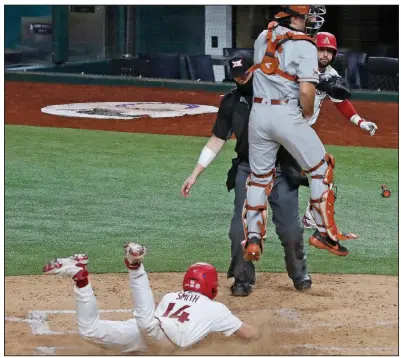  ?? (Special to the Democrat-Gazette/James D. Smith) ?? Cullen Smith scores during the fourth inning to give No. 8 Arkansas a 1-0 lead en route to a 4-0 victory over No. 9 Texas on Sunday in Arlington, Texas. It was the second victory in as many days for the Razorbacks. More photos at arkansason­line.com/222uatexas/