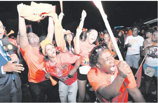  ?? RUDOLPH BROWN/PHOTOGRAPH­ER ?? Supporters of Jesse Clarke celebrate at the People’s National Party’s headquarte­rs in St Andrew last night after he defeated Kari Douglas of the Jamaica Labour Party. Douglas, the incumbent, switched parties in 2020.