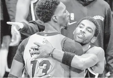  ?? FRANK FRANKLIN II/AP ?? Nets’ Kyrie Irving, right, hugs the Heat’s Bam Adebayo after Saturday night’s game in New York.