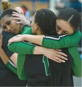  ?? BRIAN KRISTA/BALTIMORE SUN MEDIA ?? Arundel’s volleyball players consoles one another after their loss to Urbana in the Class 4A state volleyball championsh­ip match at Harford Community College’s APGFCU Arena on Thursday.