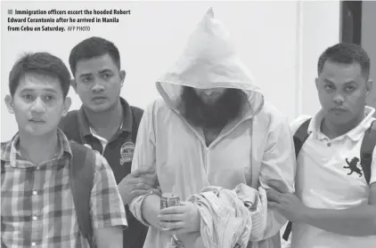  ??  ?? Immigratio­n officers escort the hooded Robert Edward Cerantonio after he arrived in Manila from Cebu on Saturday.