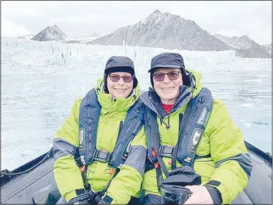  ?? (Submitted photos) ?? Denise and Jim Klinger of Bella Vista are pictured in a heavy duty inflatable boat with a glacier in the background during their recent trip to Antarctica.