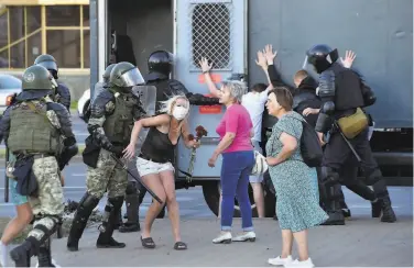  ?? Sergei Gapon / AFP / Getty Images ?? Police detain women protesting Belarus’ election and the subsequent clampdown on dissent this week.