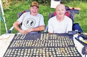  ?? ?? > Metal detectoris­t John McGimpsey, left, and c colleague Tony Cummins with the forged coins