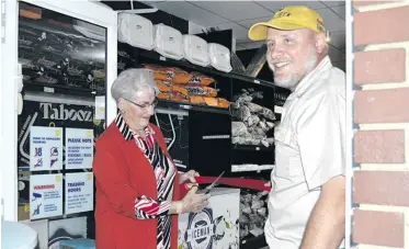  ?? ?? Saartjie Breytenbac­h cuts the ribbon with her son, Charl Breytenbac­h.