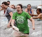  ?? Tyler Sizemore/Hearst Connecticu­t Media ?? Caitlin Heaton, of Litchfield, N.H., plunges into the frigid waters of the Long Island Sound at SoundWater­s’ first “Super Splash” event at Cove Island Park in Stamford last Sunday.