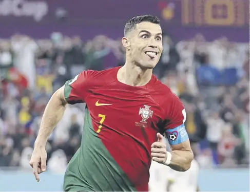  ?? ?? ↑ Cristiano Ronaldo celebrates opening the scoring from the penalty spot in Portugal’s 3-2 win against Ghana yesterday