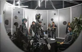  ?? RESHMA KIRPALANI / AMERICAN-STATESMAN 2017 ?? Dr. Hiroshi Ishiguro looked at his androids Ripliee S1 and U, which were unveiled at Japan Factory during SXSW Interactiv­e.