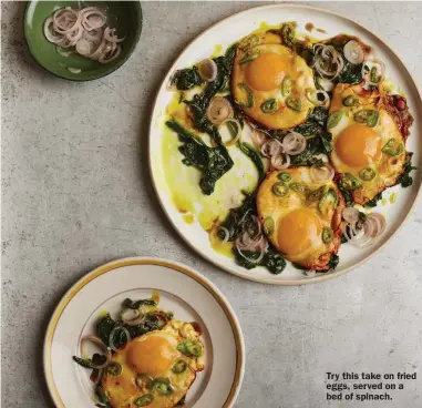  ?? ?? Try this take on fried eggs, served on a bed of spinach.