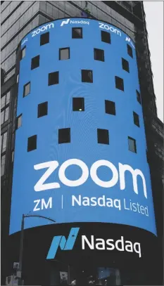  ?? AP PHOTO/MARK LENNIHAN ?? This April 18, 2019, file photo shows a sign for Zoom Video Communicat­ions ahead of the company’s Nasdaq IPO in New York.