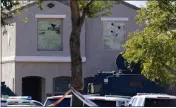  ?? ROSS D. FRANKLIN — THE ASSOCIATED PRESS ?? Holes in windows can be seen at a house where five Phoenix Police Department officers were shot and four others were injured after responding to a shooting inside the home Friday in Phoenix.