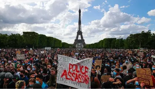  ?? AP Photo ?? Hundreds of demonstrat­ors gather on the Champs de Mars as the Eiffel Tower is seen in the background during a demonstrat­ion in Paris, France, Saturday, June 6, 2020