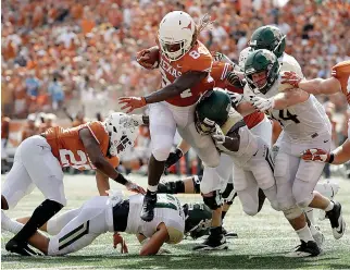  ?? AP Photo/Eric Gay ?? ■ Texas wide receiver Lil'Jordan Humphrey (84) runs for a 3-yard touchdown against Baylor during the first half of an NCAA college football game Saturday in Austin.