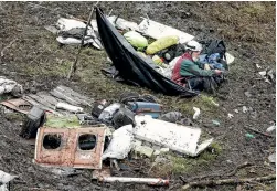  ?? PHOTO: REUTERS ?? A rescue worker sits among wreckage from the plane that crashed into the Colombian jungle near Medellin, killing 71 people.