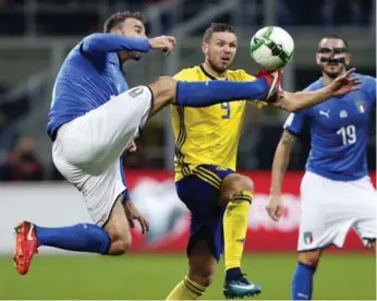  ?? ANTONIO CALANNI/THE ASSOCIATED PRESS ?? Italy’s Andrea Barzagli, left, and Sweden’s Marcus Berg vie for the ball during the World Cup qualifying playoff second leg match at the San Siro stadium in Milan, Italy on Monday.