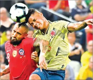  ?? NELSON ALMEIDA/AFP ?? Chile’s Arturo Vidal (left) and Colombia’s Wilmar Barrios vie for the ball during their Copa America quarter-final at the Corinthian­s Arena in Sao Paulo on Friday.