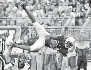  ?? CHRIS KNIGHT/AP ?? Penn State’s Juwan Johnson (84) makes a catch in front of Appalachia­n State’s Clifton Duck (4) during the second half of Saturday’s game in State College, Pa.