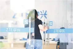  ??  ?? A woman enters a service centre of ZTE Corp in Hangzhou, Zhejiang province. Employees of ZTE Corp, the Chinese telecom equipment maker, are cheering a tweet by US President Donald Trump that suggested a resolution is in sight for a devastatin­g ban on...