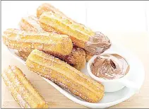  ?? ?? Churros can be eaten plain or topped with sugar or honey for extra sweetness. Some people also enjoy them with a thick chocolate or caramel sauce dip, making them even more delightful for those with a sweet tooth.