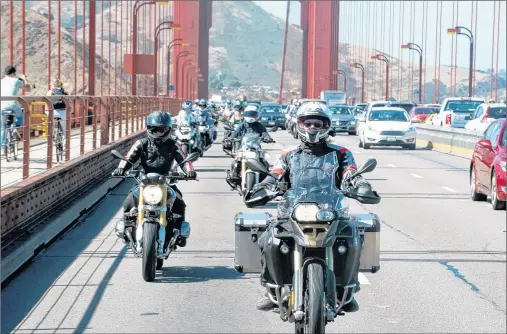  ?? ALISA CLICKENGER VIA AP ?? Alisa Clickenger leads a group of women riders over the Golden Gate Bridge in San Francisco in July 2016 at the end of a cross-country trip to honour two sisters from Brooklyn, N.Y., who made a similar ride in 1916.