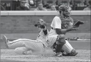  ?? The Associated Press ?? ELECTRIC SLIDE: Buster Posey, left, slides past New York Mets catcher Kevin Plawecki to score on a double by Christian Arroyo during a four-run ninth inning for the San Francisco Giants and a 6-5 road victory Wednesday.