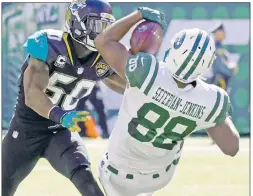  ?? AP; USA TODAY Sports ?? EYES ON THE PRIZE: Austin Seferian-Jenkins, making an acrobatic catch in Sunday’s win over the Jaguars, and Josh McCown (right) know the Jets have to keep their focus against a winless team like the Browns.