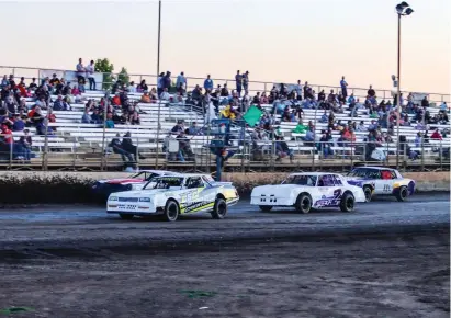  ?? Courtesy of Jessica Cucuk ?? Hobby Stock drivers race into turn one at Marysville Raceway Park on Simpson Lane.