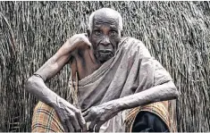  ??  ?? Left, witch doctor Yembe conducts a ritual cleansing at Kaya Godhoma. Above, Duni Nzahi Mseche, 89, was forced to flee his home after his three grandsons demanded that he sell his farm. Right, an accused witch with a ritual trumpet