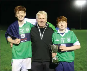  ??  ?? Darragh, Charlie and Gavin Rochford celebrate after Bray Emmets defeated St Patrick’s in the Minor Shield football final in Ballinakil­l last Friday night.