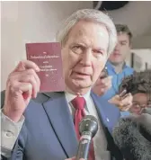  ?? J. SCOTT APPLEWHITE/AP ?? U.S. Rep. Walter B. Jones Jr., R-N.C., holds a copy of the Constituti­on while talking to reporters in 2015.